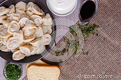 Boiled dumplings national dish of many nations with sour cream, soy sauce Stock Photo