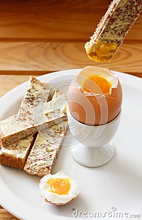 Boiled egg and buttered toast Stock Photo