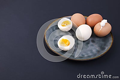 Boiled eggs on a plate. Black background. Place for text. Protein and nutrition Stock Photo