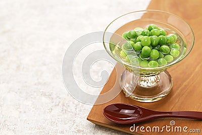 Boiled green peas and then soaked in Japanese dashi soup Stock Photo