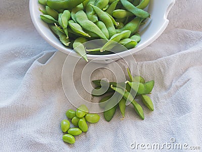 Boiled green soybeans on fabric backgroun Stock Photo