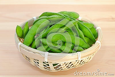 Boiled green soybeans in a small bamboo basket Stock Photo