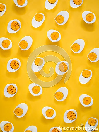Boiled half cut eggs pattern on yellow Stock Photo