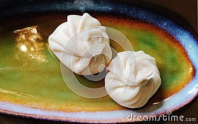 Boiled khinkali dumplings in a beautiful plate. Food in the restaurant .View from above. Stock Photo