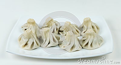 Boiled khinkalis Georgian dumpling on a white plate Stock Photo