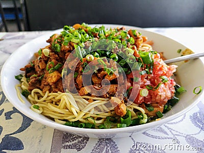 Boiled noodles with octopus stew and tomato chutney. Stock Photo