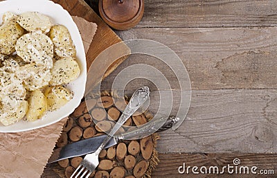 Boiled potatoes on a white plate. Dietary food. Wooden background, wooden cutlery. View from above Stock Photo