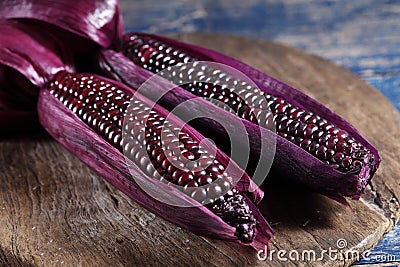 Boiled purple corn on wooden tray in rustic kitchen Stock Photo