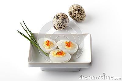 Boiled quail eggs with trout eggs and chive Stock Photo