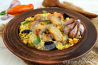 Boiled rice with roasted chicken, carrots, spices (traditional Asian dish - pilaf). Stock Photo