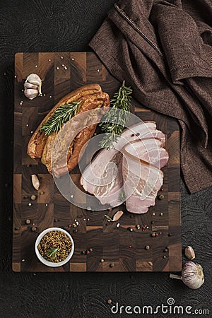 Boiled smoked pork brisket on a wooden board with grainy mustard Stock Photo
