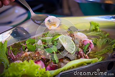 Boiled spicy squids with salad and lime. Stock Photo