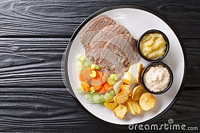 Boiled veal or Tafelspitz is the king of the beef dishes in Vienna close-up in a plate. horizontal top view Stock Photo