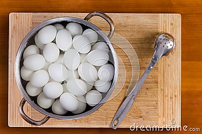 Boiled white hens eggs cooling for decorating Stock Photo