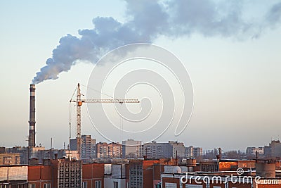 Boiler pipe smoke above roofs of high-rise apartment buildings Stock Photo