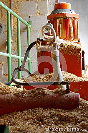 Boiler room hydraulic system supplying sawdust Stock Photo