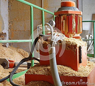 Boiler room hydraulic system supplying wood sawdust Stock Photo