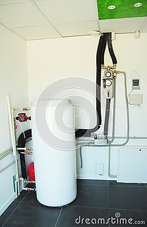 Boiler room with solar water heater tank for house energy efficiency. Modern gas boiler, heating electric warm water system Stock Photo