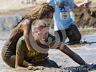 BOISE, IDAHO/USA - AUGUST 10: Unidentified couple horsing around in the mud pit near the finish at the The Dirty Dash in Boise, Id Editorial Stock Photo