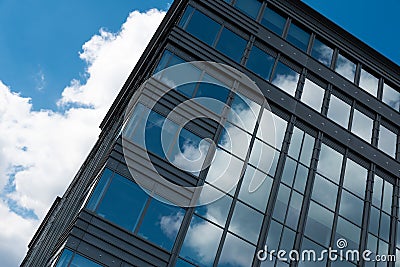 Boitsfort, Brussels Capital Region - Belgium - Blue clouds reflecting in the windows of a high rise office building at Boulevard Editorial Stock Photo