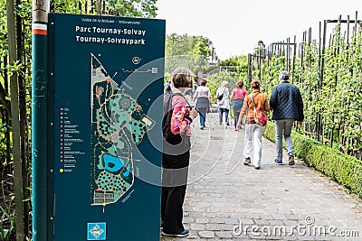 Boitsfort, Brussels Capital Region - Belgium - Sign of the Tournay-Solvay city park wwith people passing by Editorial Stock Photo