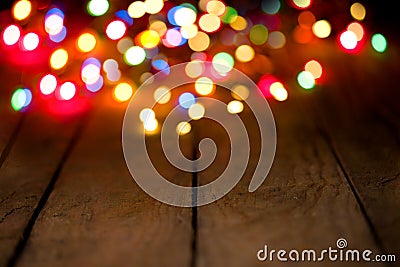 Bokeh background with colorful lights on wooden boards Stock Photo