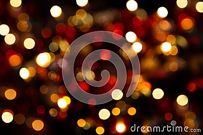 Bokeh in a circle on a dark background. Blurred christmas wreath. Abstract photograph. Yellow, red lights on a black background Stock Photo