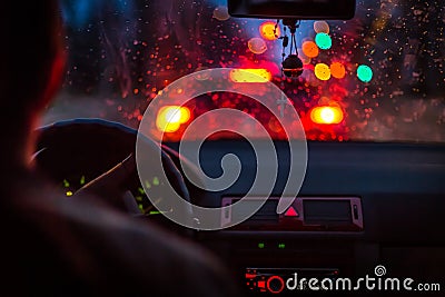 Bokeh lights from traffic jam through a car windscreen on Rainy night in the big city Stock Photo