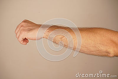 The bold gesture conveys a powerful message of unity or defiance. Set against a neutral background, the focus remains on Stock Photo