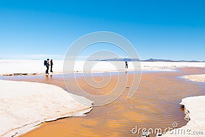 Bolivia Colchani hikers in the Salar of Uyuni Editorial Stock Photo