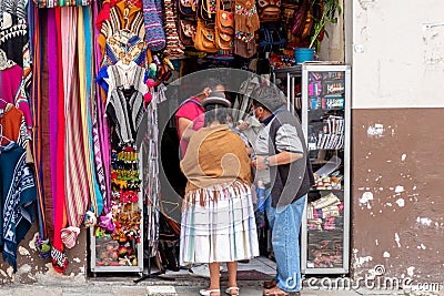 A Bolivian couple are next to the store Editorial Stock Photo