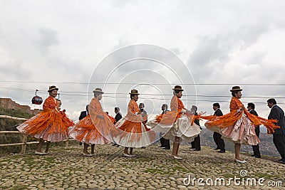 Bolivian women dancing in folklore clothes during carnival in La Editorial Stock Photo