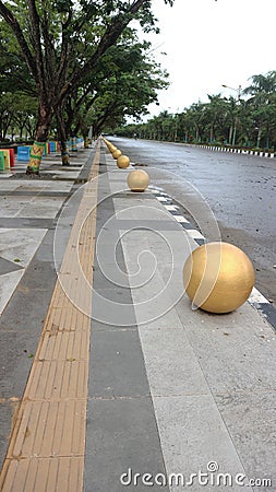 bollard ball barrier between road and sidewalk part of street furniture Stock Photo