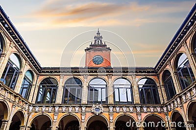 Bologna, Italy Biblioteca Comunale dell'Archiginnasio courtyard with clock tower against sky Stock Photo