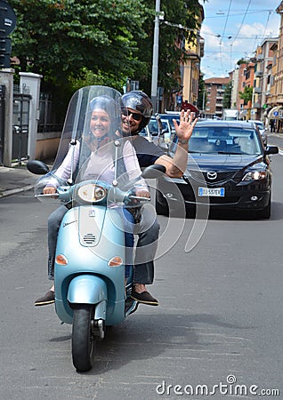 Young couple on a scooter, scooters are a part of the culture, Editorial Stock Photo