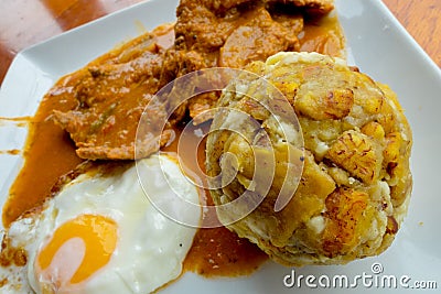 Bolon de verde with fried eggs and meat stew ecuadorian food galapagos Stock Photo