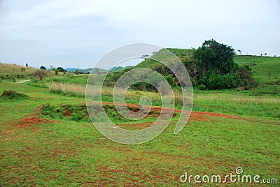 Bomb craters from the Vietnam War surround giant megalithic stone urns at the Plain of Jars archaeological site in Loas. Stock Photo