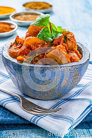 Bombay aloo - Indian spiced potatoes with tomato sauce Stock Photo