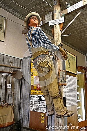 Mannequin lineman climbs a pole Editorial Stock Photo