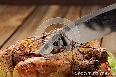 Bondage shibari roasted chicken on wooden background, cutting co Stock Photo