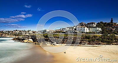Bondi Beach in Sydney NSW Australia on a sunny winters day partly cloudy skies Pacific Ocean waves and nice sandy beach Stock Photo