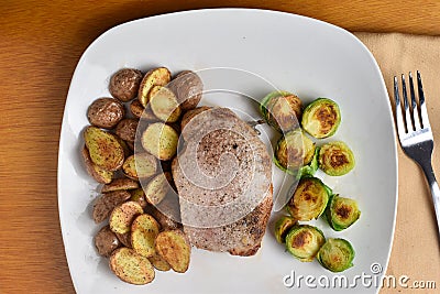 boneless pock chop with sauteed brussel sprouts and potatoes Stock Photo