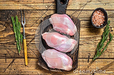 Boneless Raw Chicken thigh fillet. Wooden background. Top view Stock Photo