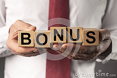 Bonus word on cubes in male hands Stock Photo