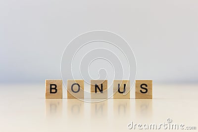 `BONUS` word wooden cube on wooden table Stock Photo