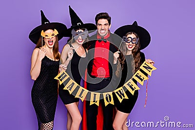 Boo. Terrifying. Portrait of dangerous creepy spooky group of people witches conjurer sorcerer hold ornament for october Stock Photo