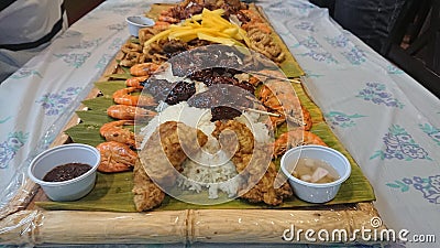 Boodle Fight Filipino traditional food preparation based on military practice of eating. Stock Photo