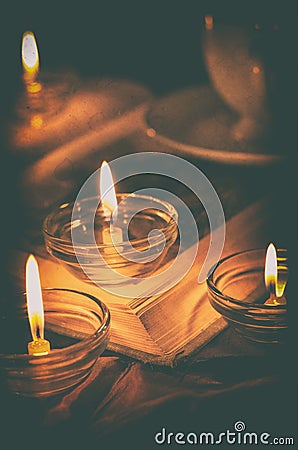 Book by candlelight. Stock Photo