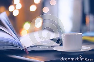 Book and coffee with magic bokeh background Stock Photo