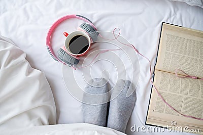 Book and cup of coffee on white bed with copy space. Stock Photo